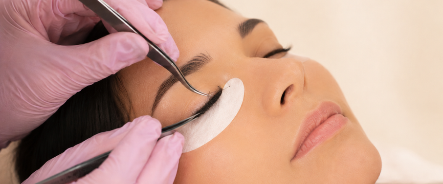Lash artist carefully separating extensions with tweezers.