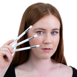 Women holding 3 eyelash extension cleansing brushes near her face